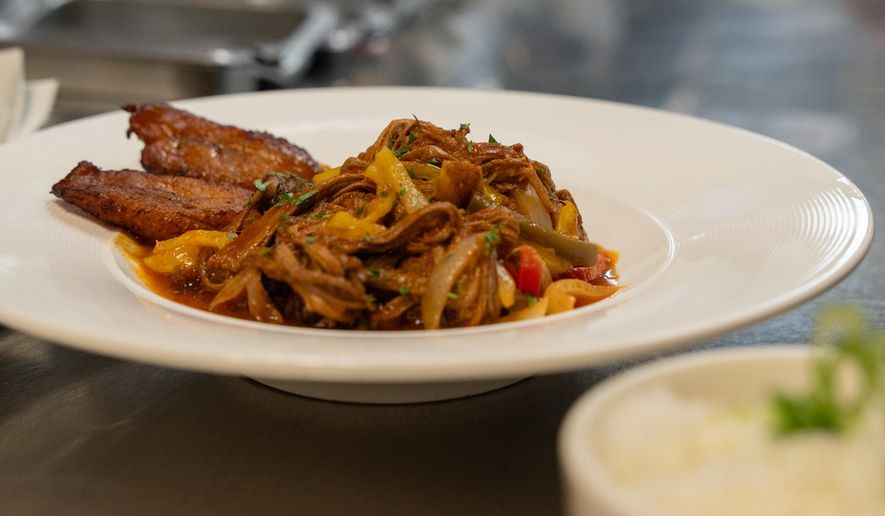 A ropa vieja dish from Cuba Libre Restaurant and Rum Bar's standard menu is prepared for serving at Cuba Libre Restaurant and Rum Bar in Philadelphia, on Friday, March 6, 2026. (AP Photo/Mingson Lau)