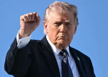 President Donald Trump gestures as he boards Air Force One Sunday at Palm Beach International Airport in West Palm Beach, Florida.