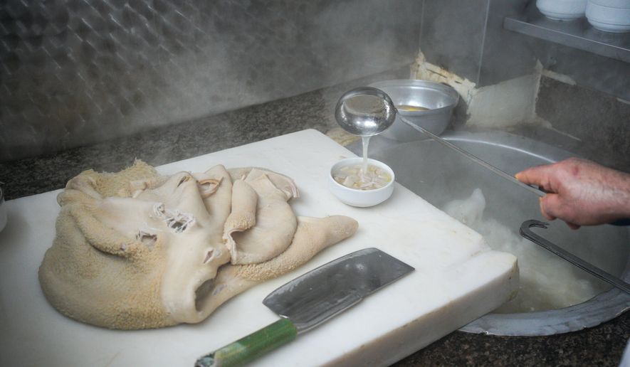 A man cooks traditional tripe soup, known as "iskembe" in Turkish and "patsas" in Greek, in a restaurant in Istanbul, Turkey, Friday, March 27, 2026. (AP Photo/Emrah Gurel)