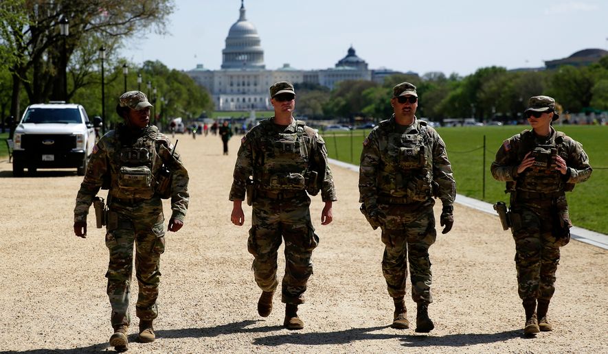 National Guard patrol the Washington Mall, with the U.S. Capitol in the background, Tuesday, April 7, 2026, in Washington. (AP Photo/Rahmat Gul)