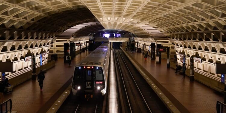 A work vehicle hits a stopped Washington Metro train, injuring 11