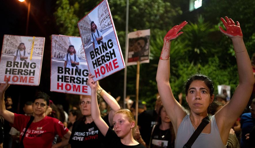 FILE - Friends and supporters of Israeli-American hostage Hersh Goldberg-Polin, who was kidnapped to the Gaza Strip on Oct. 7, 2023, protest outside of Israeli Prime Minister Benjamin Netanyahu's residence to demand a deal for the immediate release of all hostages, after Hamas released a video of Goldberg-Polin, in Jerusalem, Wednesday, April 24, 2024. (AP Photo/Maya Alleruzzo, File)