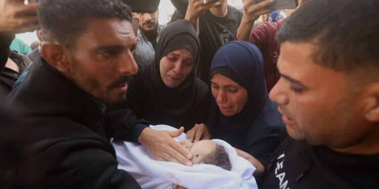 Palestinians hold funerals for pregnant woman and her children killed in Israeli strikes