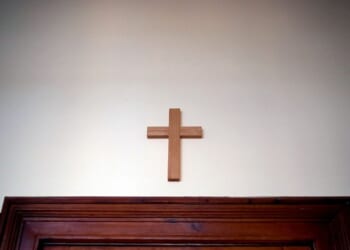 A wooden cross hangs over a door in an empty classroom at the Domgymnasium grammar school in Magdeburg, eastern Germany, on March 25, 2020.