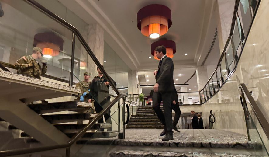 Broken glass is seen on the floor as law enforcement respond to an incident at the White House Correspondents Dinner, Saturday, April 25, 2026, in Washington. (AP Photo/Mark Schiefelbein)