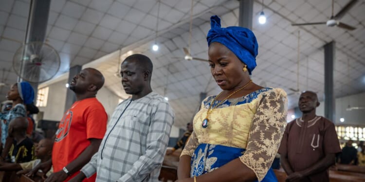 Roman Catholics pray at Saint Michael's Cathedral during the Sunday service in Minna on Nov. 30, 2025.