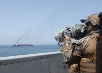 In this handout photo provided by U.S. Central Command, U.S. forces patrol the Arabian Sea near M/V Touska on April 20, 2026, after firing upon the Iranian-flagged vessel that the U.S. accused of attempting to violate the U.S. naval blockade of Iranian ports near the Strait of Hormuz.