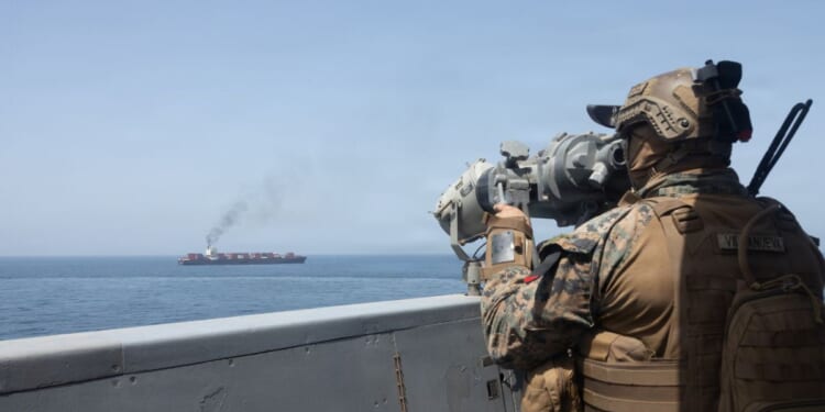 In this handout photo provided by U.S. Central Command, U.S. forces patrol the Arabian Sea near M/V Touska on April 20, 2026, after firing upon the Iranian-flagged vessel that the U.S. accused of attempting to violate the U.S. naval blockade of Iranian ports near the Strait of Hormuz.