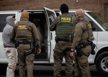 People detained earlier in the day are taken to a parking lot on the far north side of the city before being transferred to an Immigration and Customs Enforcement facility on Oct. 31, 2025, in Chicago, Illinois.