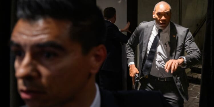 Agents draw their guns at the White House Corresondents' dinner at the Washington Hilton in Washington, DC after shots are fired on April 25, 2026.