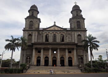 A man rides his bike in front of an old cathedral in Managua, Nicaragua on Oct. 19, 2009.