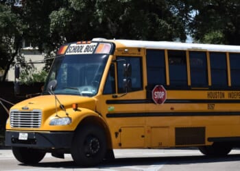 A Houston school bus charter near a water fountain in Houston, Texas.