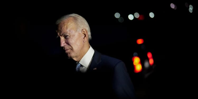 Then-Democratic presidential nominee Joe Biden talks with local firefighters as he leaves a CNN townhall in Moosic, Pennsylvania, on Sept. 17, 2020.