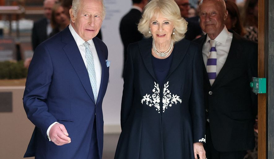 Britain's King Charles and Queen Camilla attend a presentation on the final design for the national memorial to Queen Elizabeth II at the British Museum, on the 100th anniversary of the late queen's birth, in London, Tuesday, April 21, 2026. (Toby Melville/Pool Photo via AP)