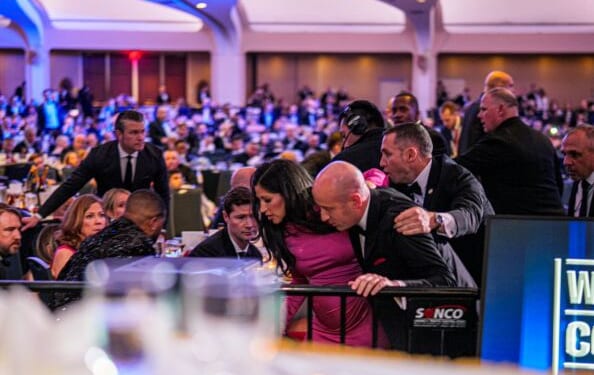 Attendees including White House Deputy Chief of Staff for Policy Stephen Miller are hustled out of the Washington Hilton ballroom on April 25, 2026.