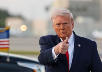 President Donald Trump waves to the media after walking off of Air Force One at Miami International Airport on April 11, 2026, in Miami, Florida.