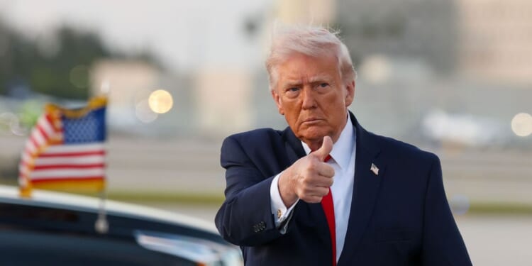 President Donald Trump waves to the media after walking off of Air Force One at Miami International Airport on April 11, 2026, in Miami, Florida.