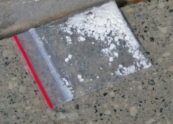 A stock photo shows a small amount of cocaine in a Ziploc baggie.