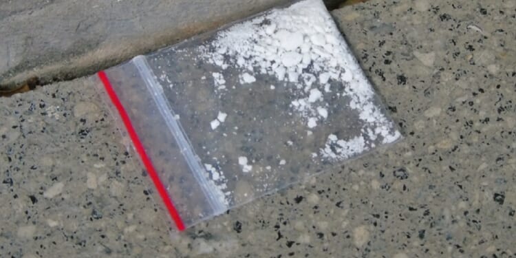 A stock photo shows a small amount of cocaine in a Ziploc baggie.