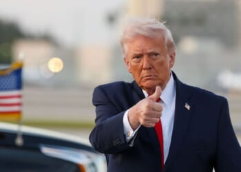 President Donald Trump waves to the media after walking off of Air Force One at Miami International Airport on April 11, 2026, in Miami, Florida.