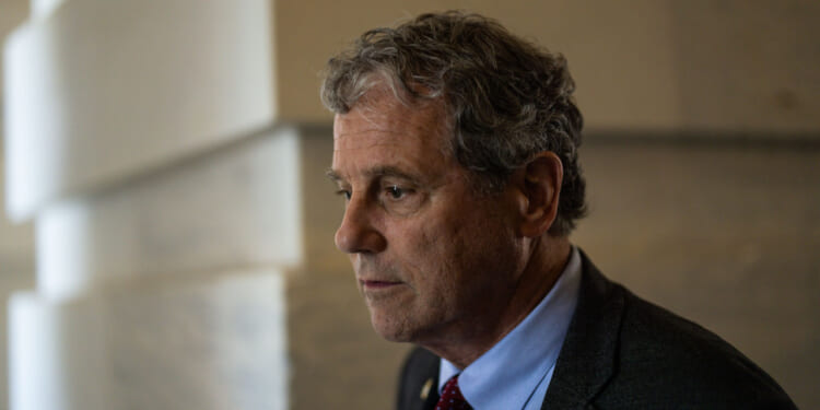 Then Sen. Sherrod Brown, D-Ohio, looks off to the side.