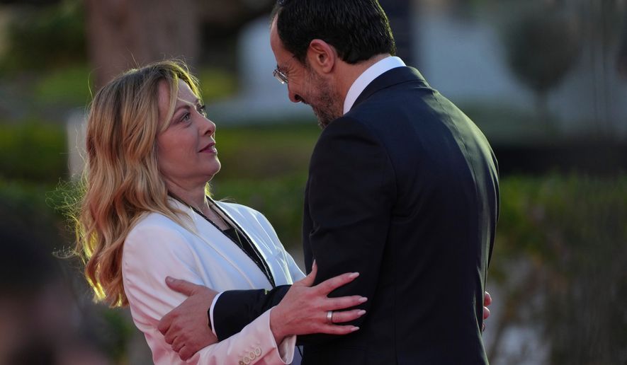 Italy's Prime Minister Giorgia Meloni, left, is welcomed by Cypriot President Nikos Christodoulides at the EU Summit in Ayia Napa, Cyprus, Thursday, April 23, 2026. (AP Photo/Petros Karadjias)