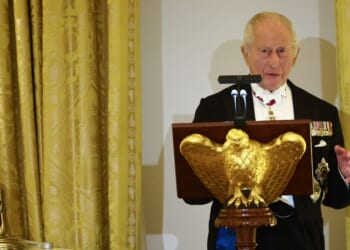 King Charles III speaks beside the original bell from the H.M.S. Trump, a World War II-era submarine and inscribed "Trump 1944," a gift to President Donald Trump during a State Dinner in the East Room of the White House in Washington, D.C., on April 28, 2026.
