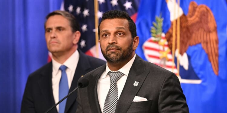 FBI Director Kash Patel stands in front of Attorney General Todd Blanche as he explains the indictment of the Southern Poverty Law Center on April 21, 2026 in at the Department of Justice in Washington, DC.