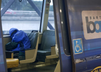 A passenger naps on a train at the MacArthur BART station in Oakland, Calif. on Tuesday, May 12, 2020. BART is joining transit agencies from around the country in seeking economic federal relief funds because of dwindling ridership during the coronavirus shutdown. (Photo By Paul Chinn/The San Francisco Chronicle via Getty Images) Crime