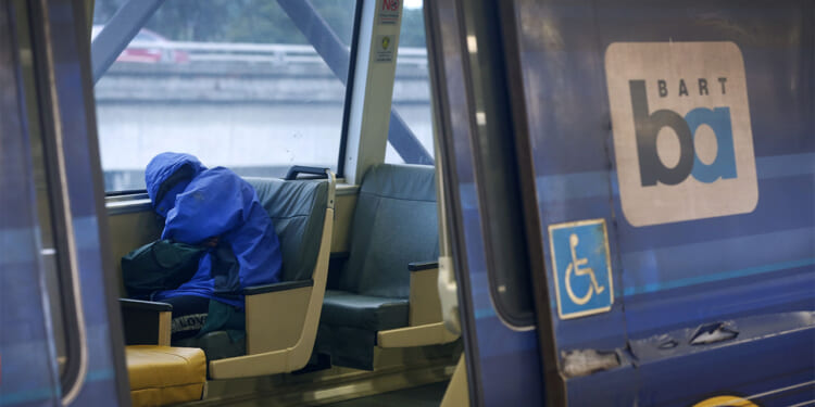 A passenger naps on a train at the MacArthur BART station in Oakland, Calif. on Tuesday, May 12, 2020. BART is joining transit agencies from around the country in seeking economic federal relief funds because of dwindling ridership during the coronavirus shutdown. (Photo By Paul Chinn/The San Francisco Chronicle via Getty Images) Crime