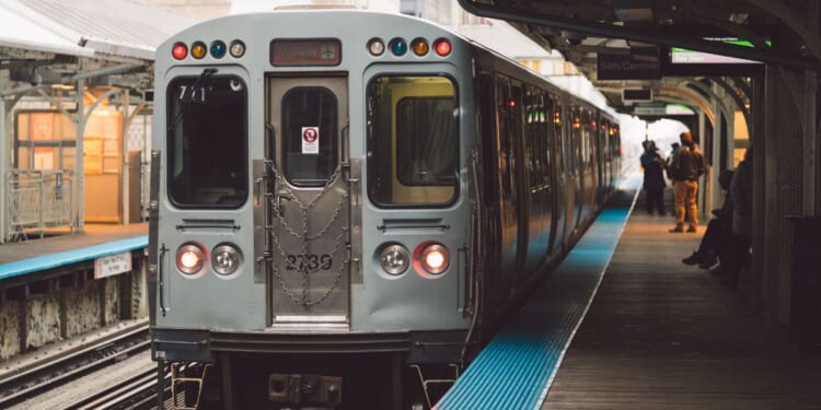 A train stationed at a railroad station platform in Chicago.