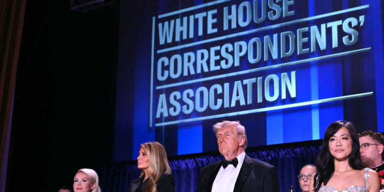 White House Press Secretary Karoline Leavitt, US First Lady Melania Trump, US President Donald Trump and CBS News senior White House correspondent Weijia Jiang stand in front of a blue backdrop reading "White House Correspondents' Dinner."