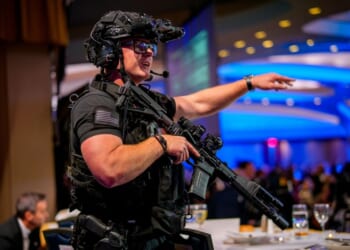 Armed Secret Service agents stand on stage at the annual White House Correspondents Association Dinner at the Washington Hilton in Washington, DC after a shooting took place on April 25, 2026.