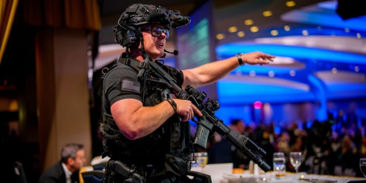 Armed Secret Service agents stand on stage at the annual White House Correspondents Association Dinner at the Washington Hilton in Washington, DC after a shooting took place on April 25, 2026.