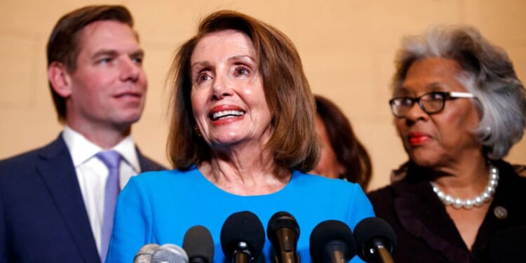 Then-House Minority Leader Nancy Pelosi, a California Democrat, is seen in a file photo from Nov. 28, 2018, with fellow Democrats Rep. Eric Swalwell, of California, and Rep. Joyce Beatty of Ohio. Until he announced his resignation in disgrace Monday, Swalwell was a familiar sight in Democratic Party photo ops on Capitol Hill, but none of his colleagues will admit to knowing anything about his alleged sexual aggression against multiple females.