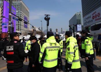 South Korean police officers patrol near the concert venue ahead of the comeback concert of K-pop boy band BTS at Gwanghwamun Square on March 21, 2026, in Seoul, South Korea.