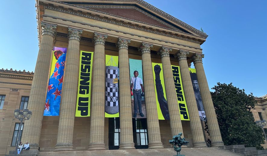 Banners for the "Rising Up: Rocky" exhibition hang outside of the Philadelphia Museum of Art in Philadelphia, Wednesday, April 22, 2026. (AP Photo/Tassanee Vejpongsa)