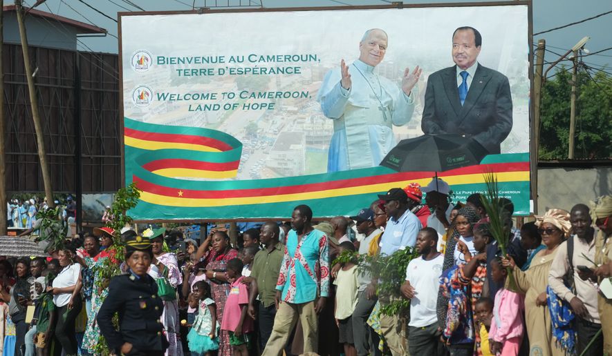People greet Pope Leo XIV upon his arrival in Yaounde, Cameroon, Wednesday, April 15, 2026, on the third day of an 11-day apostolic journey to Africa. (AP Photo/Andrew Medichini)