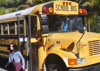A girl getting off a school bus