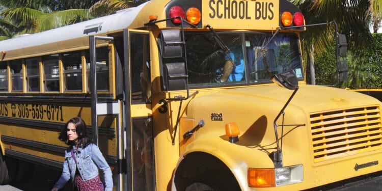 A girl getting off a school bus