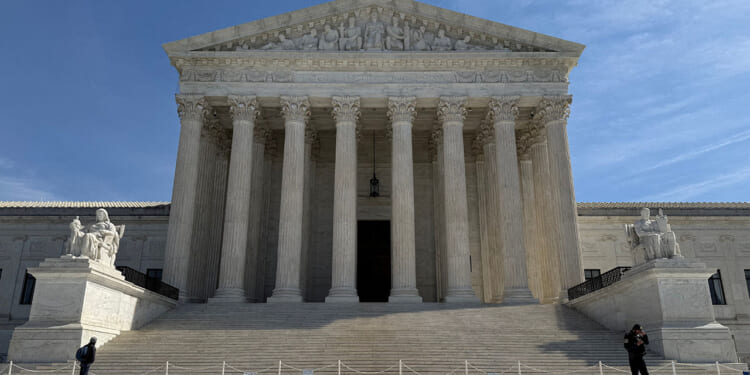 People walk outside the U.S. Supreme Court building in Washington, D.C., U.S., March 14, 2026. REUTERS/Will Dunham/File Photo