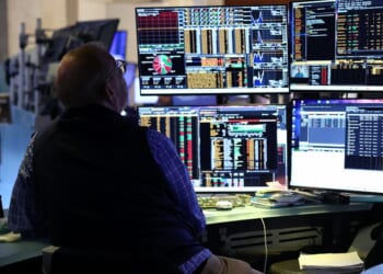 A trader works on the floor of the New York Stock Exchange during the opening bell in New York, on April 13, 2026.