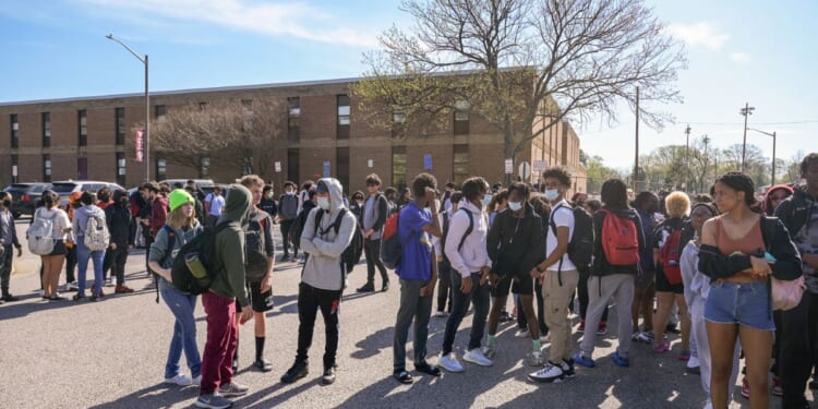 Mt. Vernon High School students participate in a student walkout against the potential confirmation of Superintendent Michelle Reid in Alexandria, Virginia, on April 14, 2022.
