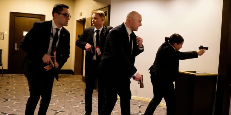 Federal agents with their guns drawn react to an incident that occurred at the annual White House Correspondents Association Dinner on April 25, 2026 in Washington, DC.