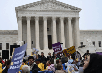 Members of the National TPS Alliance rally at the U.S. Supreme Court in Washington, D.C., on April 29. The Supreme Court is examining the revocation of Temporary Protected Status (TPS) for Haitian and Syrian migrants. (Photo by Alex WROBLEWSKI / AFP via Getty Images)