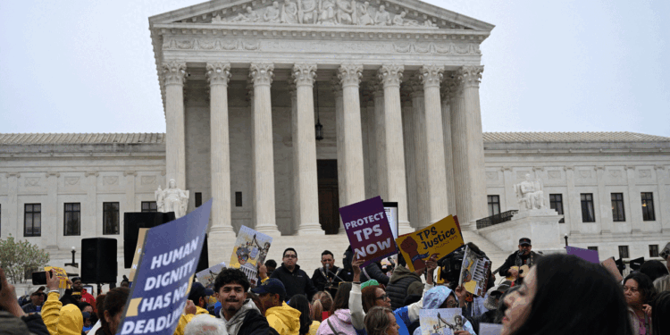 Members of the National TPS Alliance rally at the U.S. Supreme Court in Washington, D.C., on April 29. The Supreme Court is examining the revocation of Temporary Protected Status (TPS) for Haitian and Syrian migrants. (Photo by Alex WROBLEWSKI / AFP via Getty Images)