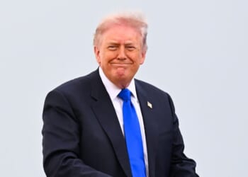 President Donald Trump smiles as he boards Air Force One on April 24, 2026, at Joint Base Andrews, Maryland.