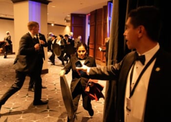 Attendees and security staff scramble in the Washington Hilton on April 25.