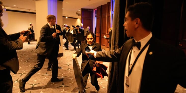 Attendees and security staff scramble in the Washington Hilton on April 25.