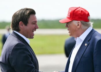 Florida Gov. Ron DeSantis shakes hands with President Donald Trump upon Trump's arrival at Dade-Collier Training and Transition Airport in Ochopee, Florida, on July 1, 2025.